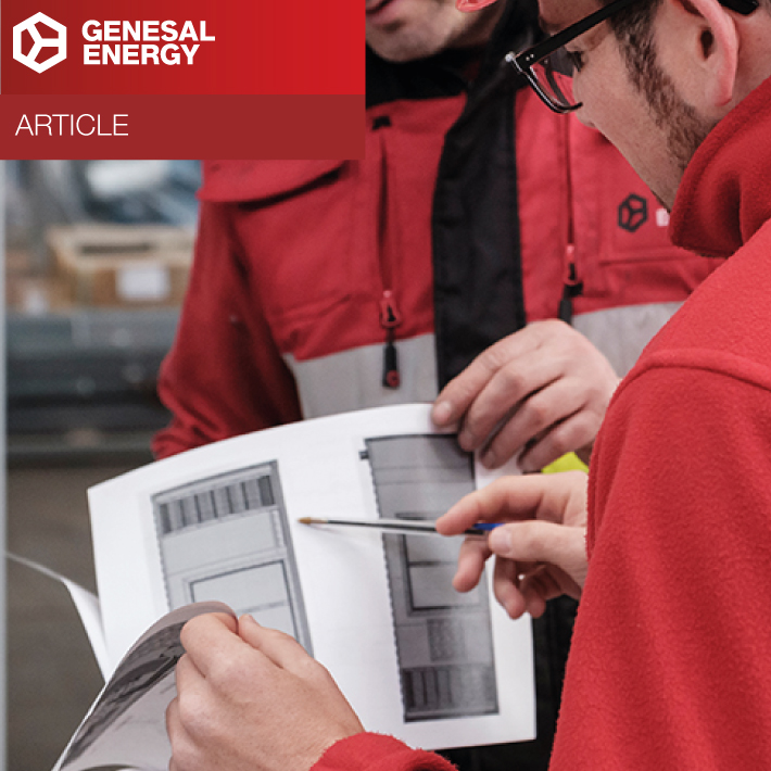 Engineers reviewing blueprints to calculate the generator you need in an industrial environment.