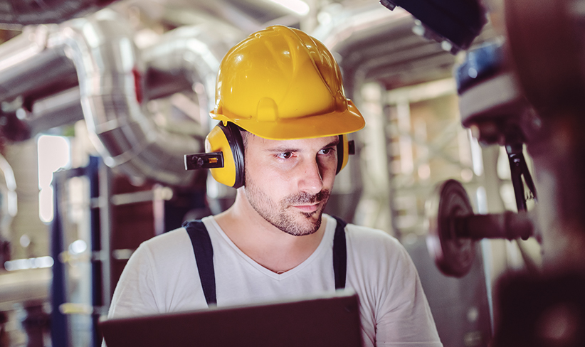 Technician connecting a generator in an industrial setting