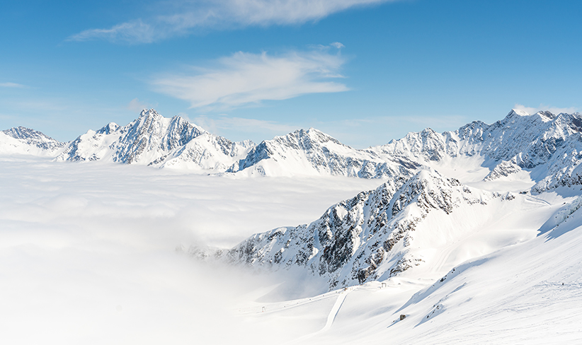 Snowy mountain landscape illustrating the challenges of operating generators in cold climates, where low temperatures can affect engine startup and efficiency.