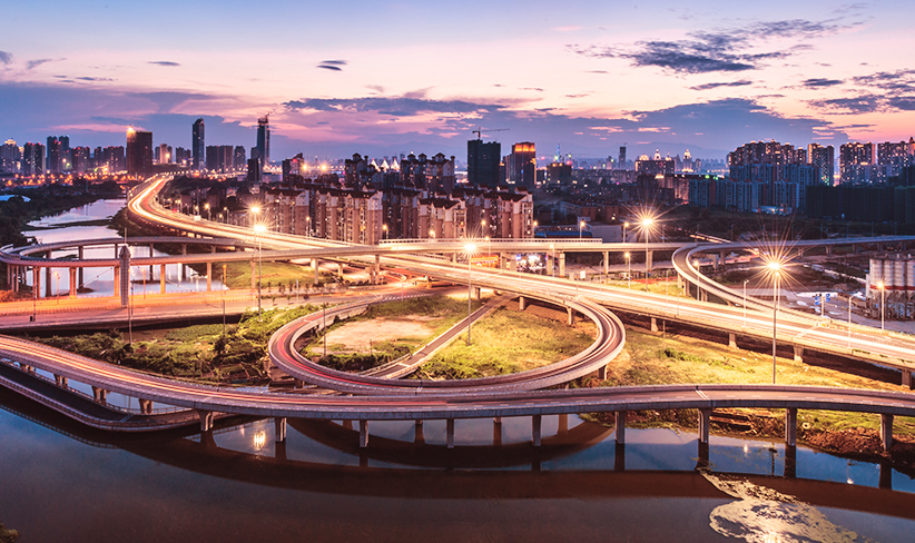Photograph of a city illuminated at sunset