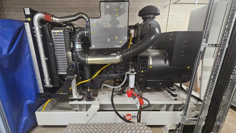 Industrial emergency generator set installed in a technical room.