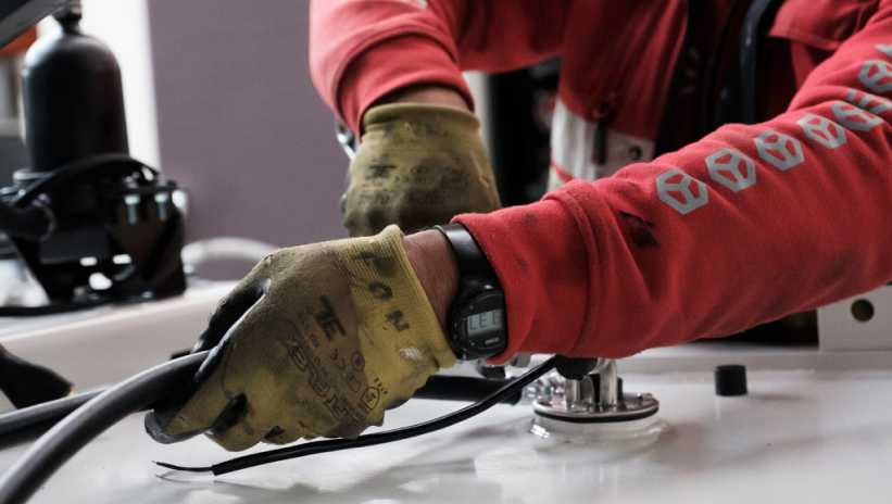 Technician performing maintenance on a generator set to prevent failures and ensure proper operation.