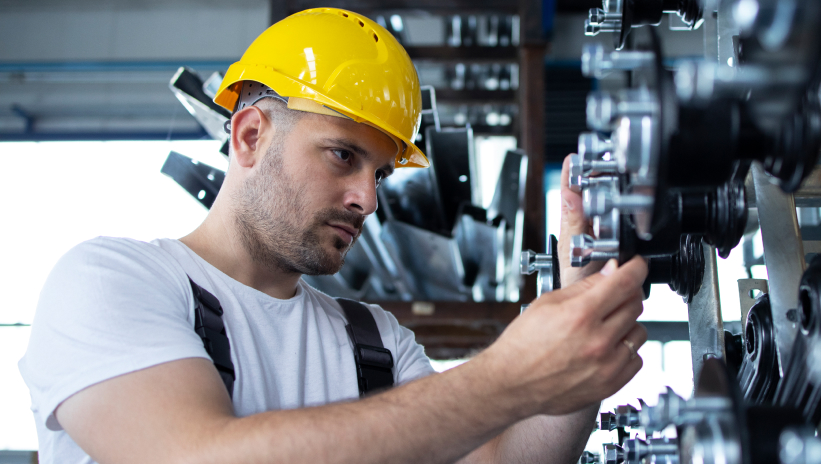 Technician performing maintenance on a generator set to prevent breakdowns and ensure proper operation.