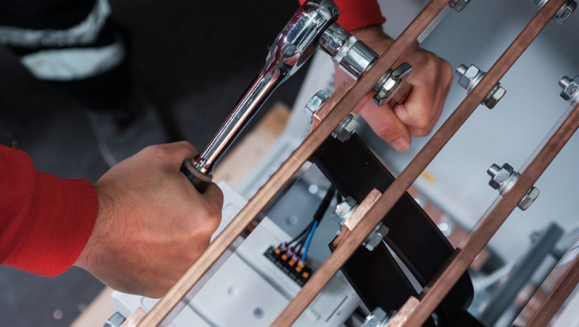 Genesal Energy technician repairing a generator set