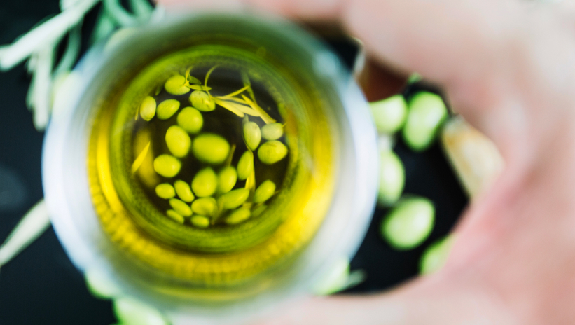 Top view of vegetable oil with olives, raw material for producing HVO as a sustainable biofuel
