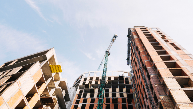 Building construction with crane on site, example of projects requiring modular generator sets